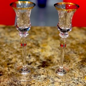 all candle holders, red sofa, glass center table